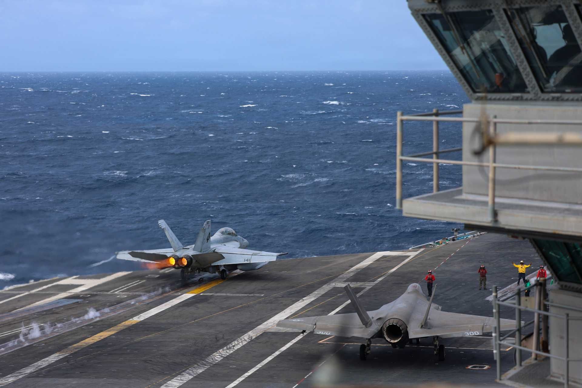 An F/A-18F Super Hornet assigned to Strike Fighter Squadron (VFA) 41 launches from the flight deck as another prepares for takeoff aboard the Nimitz-class aircraft carrier USS Abraham Lincoln (CVN 72), January 2, 2026.
