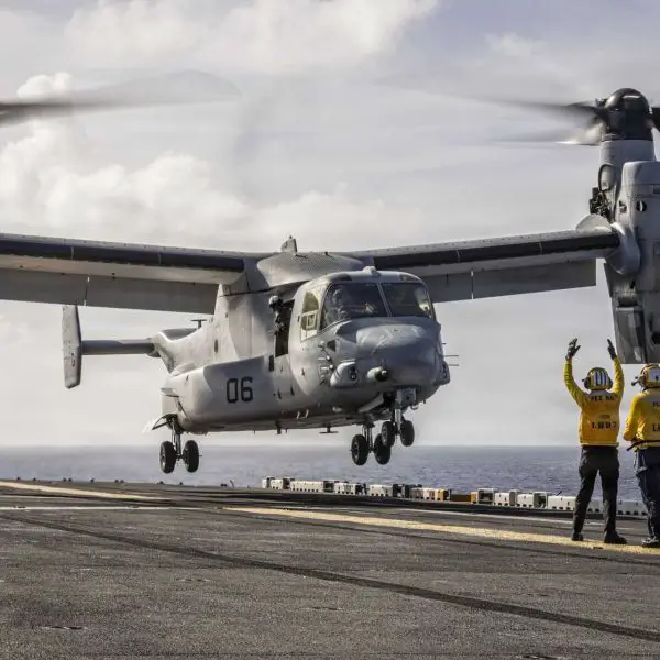 A U.S. Sailor assigned to the Iwo Jima Amphibious Ready Group directs an MV-22B Osprey as it prepares for takeoff from the flight deck of the Wasp-class amphibious assault ship USS Iwo Jima (LHD 7) during operations in the Caribbean Sea.