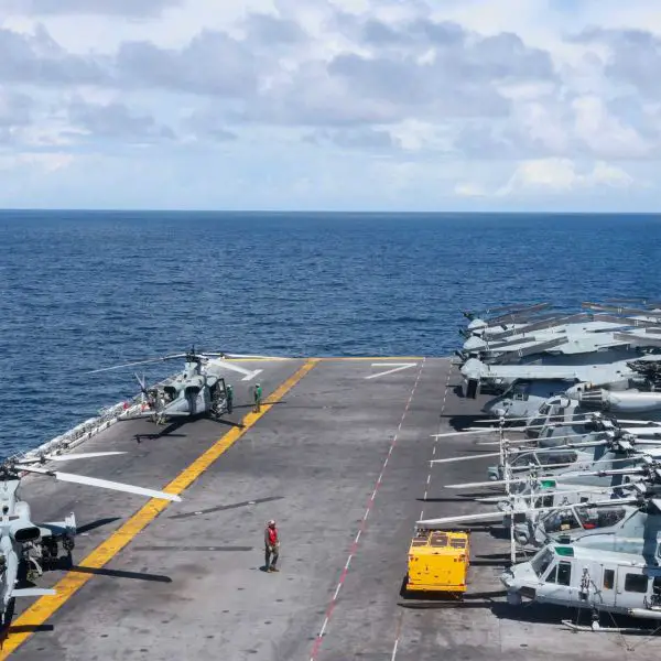 U.S. Marines, assigned to Marine Medium Tiltrotor Squadron (VMM) 263 (Reinforced), prepare an UH-1Y Huey and an AH-1Z Cobra for take-off on the flight deck of the Wasp-class amphibious assault ship USS Iwo Jima (LHD 7) deployed in the Caribbean Sea in support of the U.S. Southern Command mission.