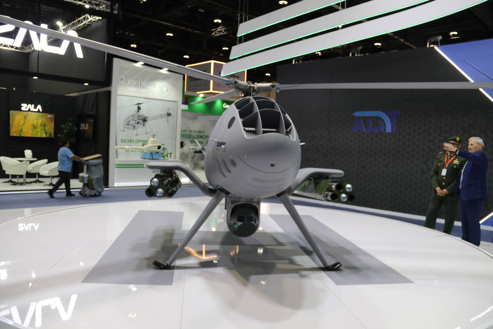The Schiebel Camcopter S-301 displayed in armed configuration at UMEX 2026, equipped with dual Thales FZ602 launchers carrying FZ275 laser-guided rockets, marking its first public appearance in the Middle East as a fully combat-capable rotary-wing Unmanned Aerial Vehicle.