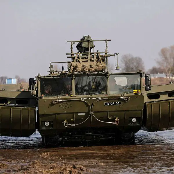 British Army M3 amphibious vehicle deploying in ferry mode during a river crossing exercise, demonstrating rapid wet gap bridging capability with full combat load under NATO operational standards.