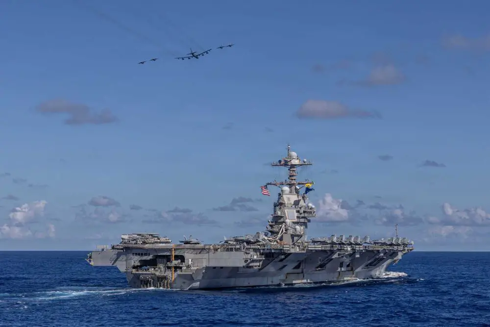 Carrier Air Wing 8 F/A-18E Super Hornets and a U.S. Air Force B-52H Stratofortress fly over the Ford-class aircraft carrier USS Gerald R. Ford (CVN 78) during operations in the western Atlantic Ocean, illustrating the expanding U.S. Navy focus on high-intensity Indo-Pacific war preparation, long-range maritime strike capability, and integrated joint-force deterrence against growing Chinese military power.