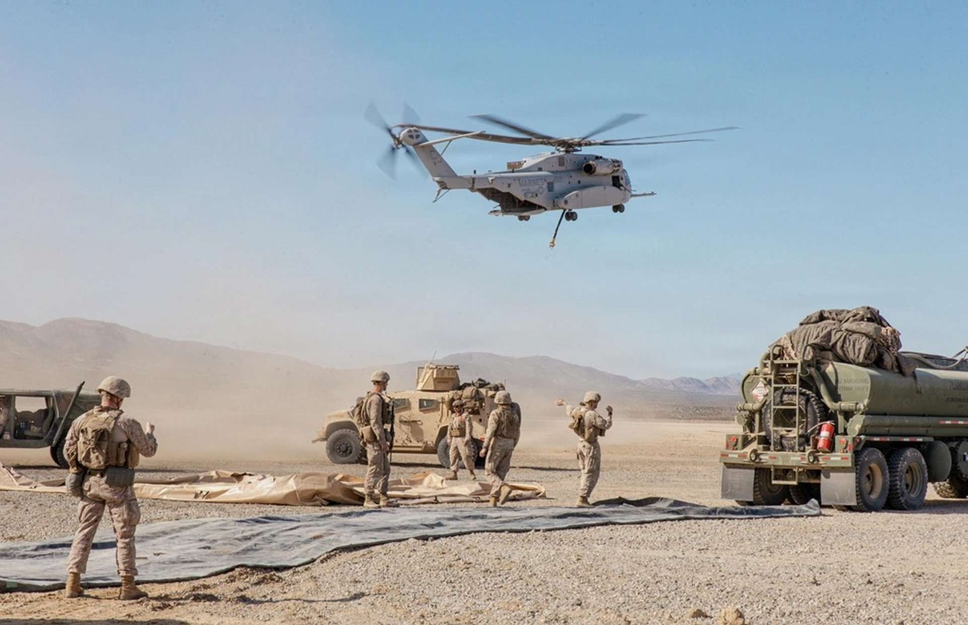 A U.S. Marine Corps CH-53K King Stallion from HMH-461 lifts off at Twentynine Palms during SLTE 1-26 as MWSS-272 establishes a forward arming and refueling point, rehearsing rapid, low-signature sustainment and heavy-lift support in a simulated contested environment (Picture source: U.S. DoW).