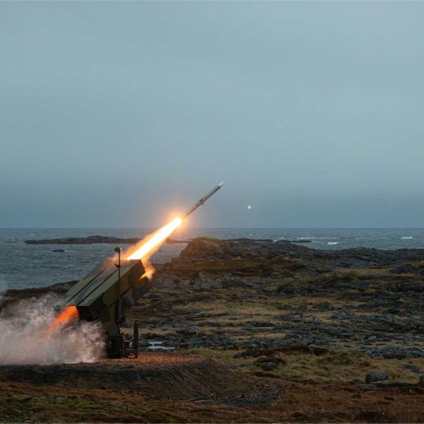 Live-fire demonstration of the NASAMS air defense system using AMRAAM missiles, showcasing rapid target engagement and networked air defense capability against aerial threats.