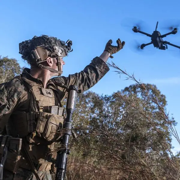 U.S. Marine Corps Cpl. launches a small drone during training in Queensland, Australia, July 2025, reflecting the War Department’s drone dominance push (Picture Source: U.S. Department of War)
