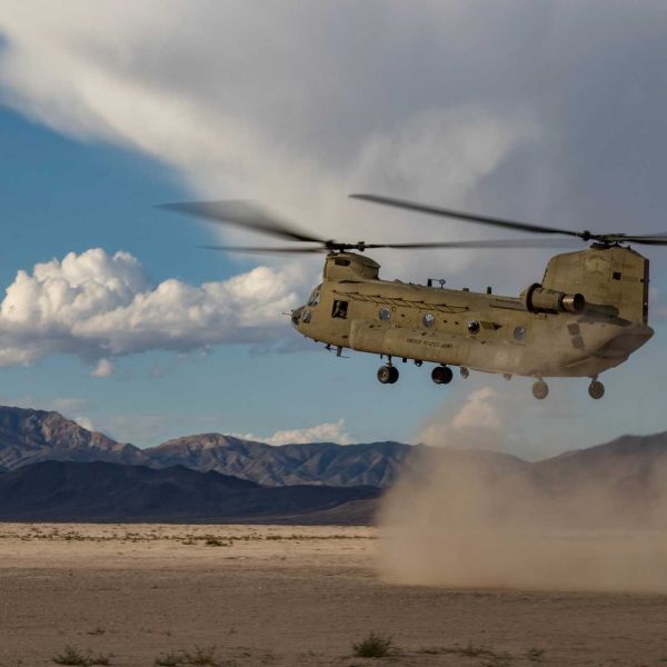 View of a U.S. Army National Guard CH-47F Chinook helicopter during landing operations, illustrating the heavy-lift platform’s operational role outside of the A2X flight test campaign.