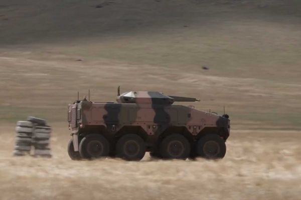 Boxer 8x8 armored vehicle equipped with the ATLAS autonomous driving system undergoing mobility trials during BAE Systems Australia testing, demonstrating driverless maneuver capability in support of future crewed and uncrewed armored operations.