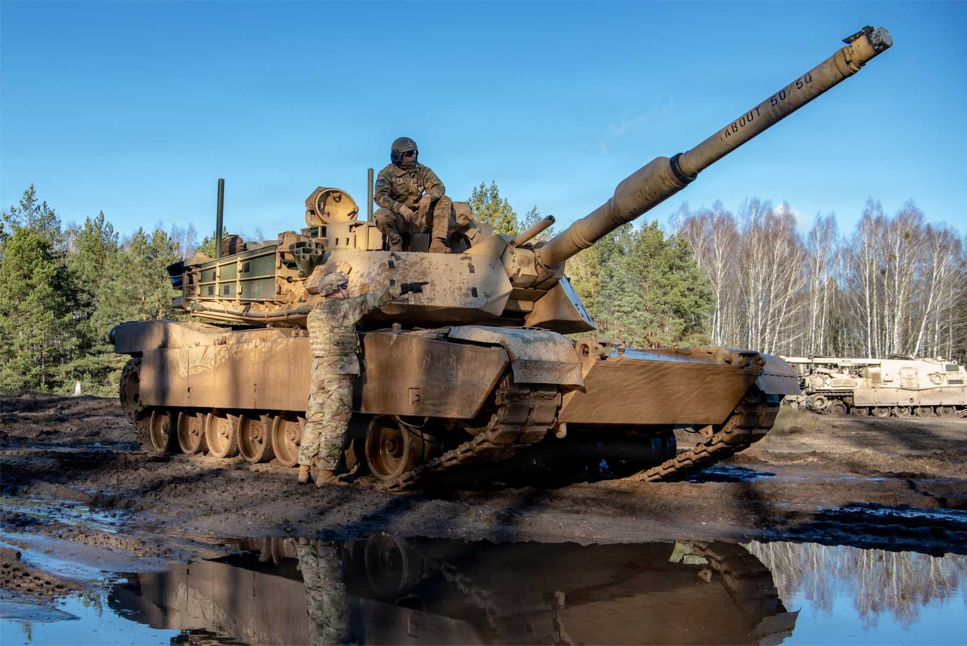 U.S. Army Soldiers from 3rd Battalion, 66th Armored Regiment, 1st Armored Brigade Combat Team, 1st Infantry Division gather ground-level intelligence from scout teams after completing a convoy movement of M1A2 Abrams tanks from their designated start point during the Forward Land Forces expansion exercise at Bemowo Piskie, Poland.
