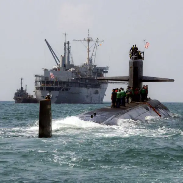 A submarine tender, such as the USS Frank Cable (AS-40), is basically a floating base that lets submarines stay on mission longer by repairing and resupplying them without forcing them to go back home. (Picture source: US Navy)