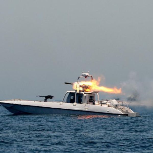 IRGC fast attack craft use speed and swarm tactics with heavy weapons to overwhelm targets in confined coastal waters (Picture source: Fars News Agency)  The incident unfolds within a sequence of escalation observed over recent days. The United States maintains a naval posture aimed at controlling commercial flows toward Iran, which Tehran describes as a maritime blockade. In response, Iranian authorities announced on April 18 the reimposition of strict control over the Strait of Hormuz, making transit conditional upon authorization. This posture does not amount to a complete closure of the passage, yet it produces a comparable effect for commercial operators by introducing a level of risk and uncertainty sufficient to disrupt traffic.   Ezoic The United Kingdom Maritime Trade Operations (UKMTO) confirms the incident in an operational alert issued on April 18, 2026, noting that the Iranian gunboats bypassed standard Very High Frequency (VHF) communication procedures before engagement. The absence of identification and warning phases marks a departure from established maritime practices, where interactions typically follow a graduated sequence. This shift indicates a deliberate coercive approach within an already heavily militarized environment.  The geographic configuration of the strait increases vessel vulnerability. At its narrowest point, it spans roughly 33 kilometers, with separated shipping lanes that constrain navigation routes. Tankers, often exceeding 250 meters in length and powered by low-speed diesel engines optimized for endurance, have limited maneuverability. When faced with fast attack craft capable of exceeding 40 knots, the imbalance becomes immediate. Under such conditions, even limited hostile action can generate disproportionate operational effects.   Map of the Strait of Hormuz highlighting the incident area located off the Iranian coastline, within a strategic maritime corridor (Army Recognition)   Ezoic The units involved correspond to assets commonly used by the IRGC Navy for asymmetric operations. Designed for speed and agility, these craft are typically armed with 12.7 mm heavy machine guns, sometimes supplemented by unguided rockets or short-range anti-ship missiles. Their reduced radar signature, combined with shallow draft, allows them to operate effectively in congested coastal environments. When deployed in groups, they can converge rapidly on a target, multiplying approach vectors and complicating response.  In contrast, the United States deploys a structured and technologically advanced naval presence. The US Navy’s Fifth Fleet, based in Bahrain, operates guided missile destroyers equipped with the Aegis Combat System, integrating sensors such as the AN SPY 1 radar capable of tracking multiple air and surface targets simultaneously at ranges exceeding 150 kilometers. These vessels are supported by P-8A Poseidon maritime patrol aircraft, fitted with surface search radars, electro optical sensors, and data links that provide real time maritime awareness. Unmanned systems complement this posture by ensuring persistent surveillance, particularly against small, fast moving contacts.  Despite this technological advantage, the operational environment remains constrained. The density of civilian traffic, combined with the proximity of Iranian territorial waters, limits freedom of action and complicates rules of engagement. A fast attack craft can close the distance with a commercial vessel within minutes, leaving little time for external intervention unless naval units are already nearby. This asymmetry allows Iranian forces to exploit ambiguity, maintaining pressure without immediately triggering a direct military response.  IRGC doctrine in the Strait of Hormuz relies on coordinated actions by small units, emphasizing speed, dispersion, and saturation. Multiple craft can operate in a semi-decentralized manner to surround a vessel and disrupt its navigation, even without sustained firepower. By contrast, US forces rely on integrated sensors, communication networks such as Link 16, and layered defense systems to maintain situational awareness and calibrate responses.  The April 18 engagement directly alters navigation conditions in the Strait of Hormuz by shifting constraints from the declaratory level to the operational domain. By reimposing strict control and resorting to live fire, Tehran establishes a precedent that compels shipping operators to account for the risk of active interdiction, potentially leading to rerouting, immediate increases in insurance premiums, and slower energy flows. At the same time, the continued US posture creates a persistent friction environment in which each interception carries the risk of involving state naval units.  In this context, the existence of a ceasefire becomes more uncertain in its practical application at sea, where tactical interactions are only partially controlled at the political level. Its durability will depend directly on the level of restraint observed during upcoming commercial transits, as well as on the ability of both parties to prevent an isolated incident from being interpreted as a deliberate breach of existing commitments.  Written By Erwan Halna du Fretay - Defense Analyst, Army Recognition Group Erwan Halna du Fretay holds a Master’s degree in International Relations and has experience studying conflicts and global arms transfers. His research interests lie in security and strategic studies, particularly the dynamics of the defense industry, the evolution of military technologies, and the strategic transformation of armed forces.  Ezoic Copyright © 2019 - 2024 Army Recognition | Webdesign by Zzam Cookie policy Legal information Ezoic ⚙ X