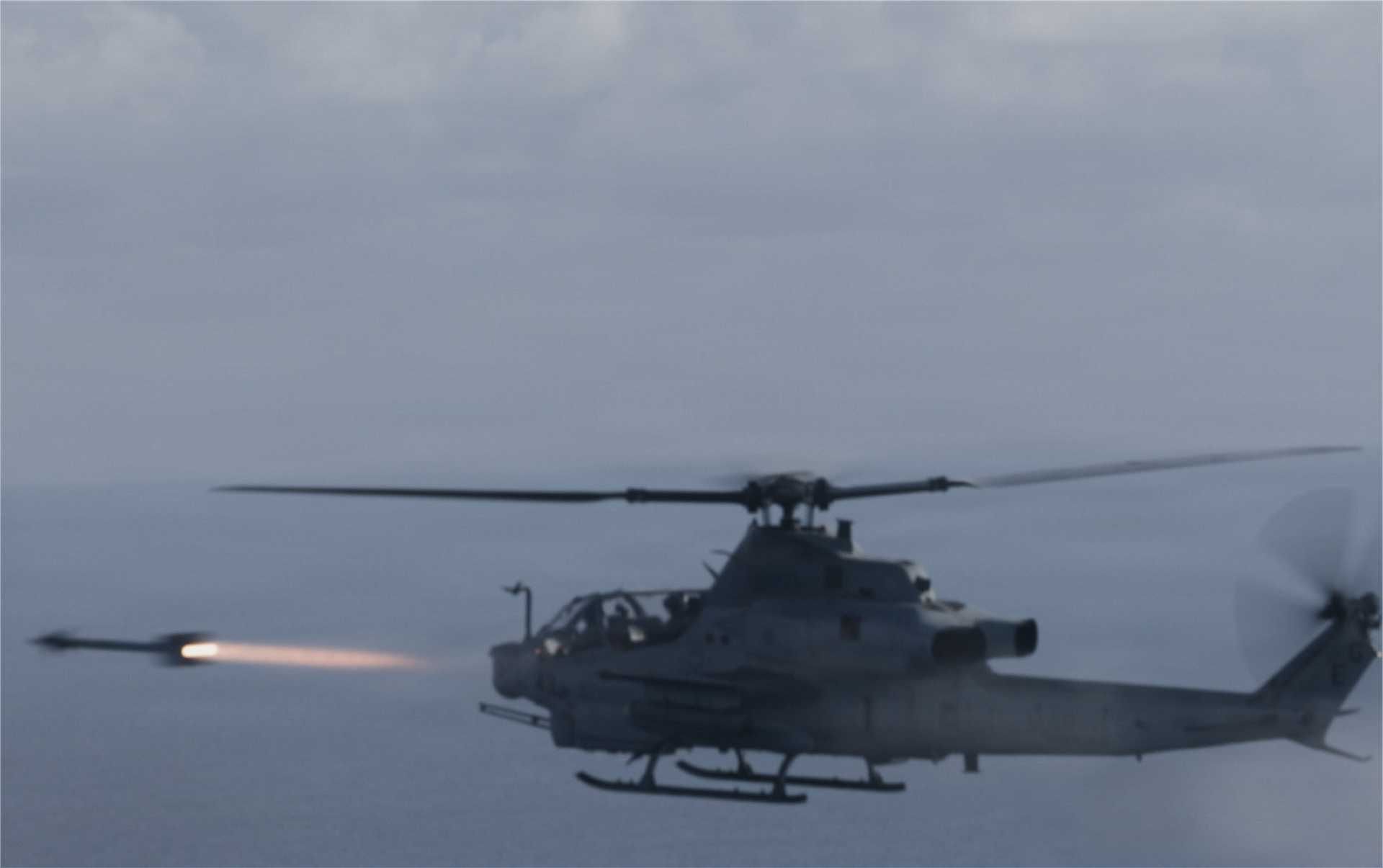 A U.S. Marine Corps AH-1Z Viper attack helicopter assigned to the 22nd Marine Expeditionary Unit conducts a live-fire launch of an AIM-9 Sidewinder missile during a training exercise over the Caribbean Sea on November 25, 2025, as part of Operation Southern Spear.