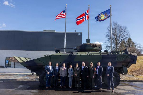 U.S. Marine Corps senior leaders and Kongsberg Defense Corp officials pose in front of a U.S. Marine Corps Amphibious Combat Vehicle during the February 20, 2026 ribbon-cutting ceremony at Kongsberg’s Johnstown, Pennsylvania facility, marking the launch of U.S.-based production for the ACV-30’s stabilized 30mm cannon system.