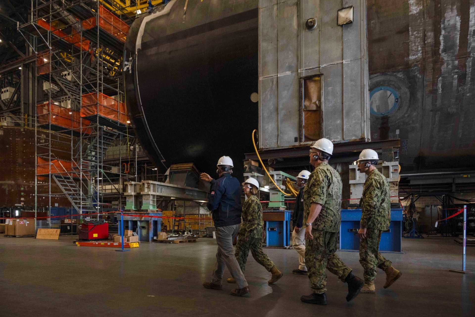 Vice Chief of Naval Operations Adm. Lisa Franchetti tours General Dynamics Electric Boat’s Quonset Point facility in Rhode Island, where modular construction and outfitting operations support future Virginia-class and Columbia-class submarines as the U.S. Navy accelerates AI-enabled submarine production modernization.