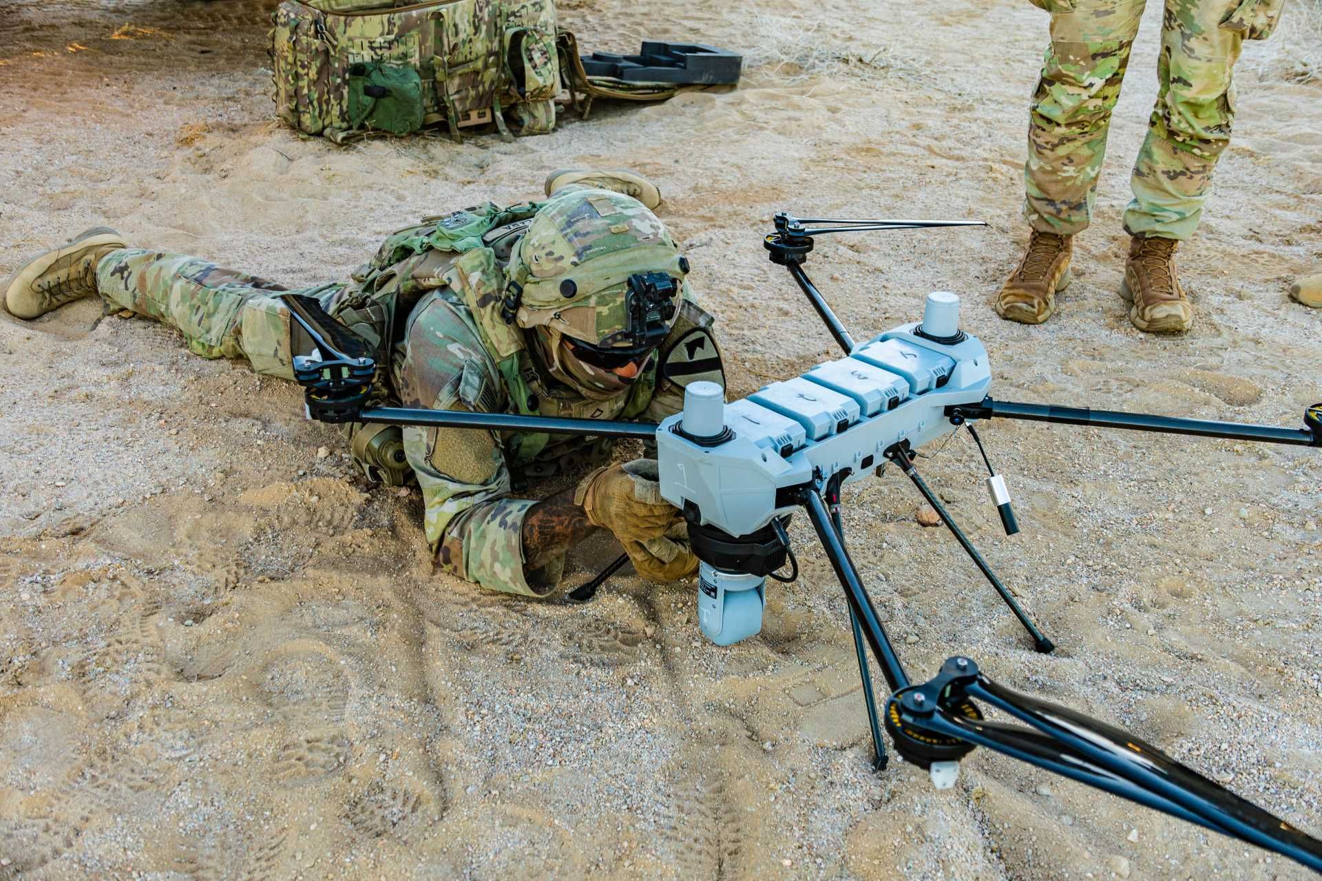 Pfc. Mario Lara, a small unmanned aircraft system operator with 1st Battalion, 8th Cavalry Regiment, 2nd Armored Brigade Combat Team, 1st Cavalry Division, prepares a C100 small UAS for launch during Rotation 26-02 at the National Training Center in Fort Irwin, California, on November 1, 2025.