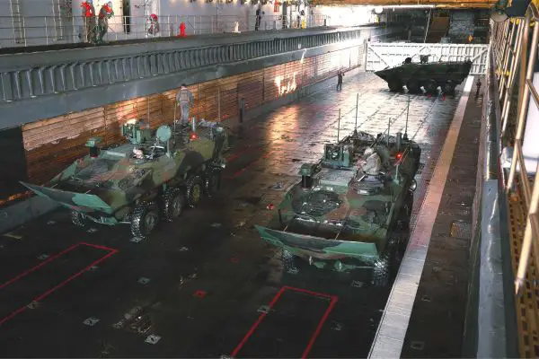 U.S. Marines assigned to the 1st Marine Division stage Amphibious Combat Vehicles inside the flooded well deck of USS Ashland (LSD 48) during ship-to-shore readiness drills off the California coast on February 20, 2026.