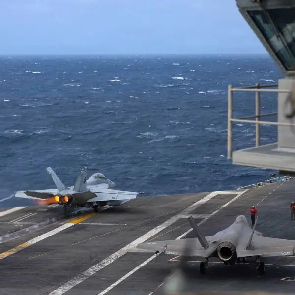 An F/A-18F Super Hornet assigned to Strike Fighter Squadron (VFA) 41 launches from the flight deck as another prepares for takeoff aboard the Nimitz-class aircraft carrier USS Abraham Lincoln (CVN 72), January 2, 2026.