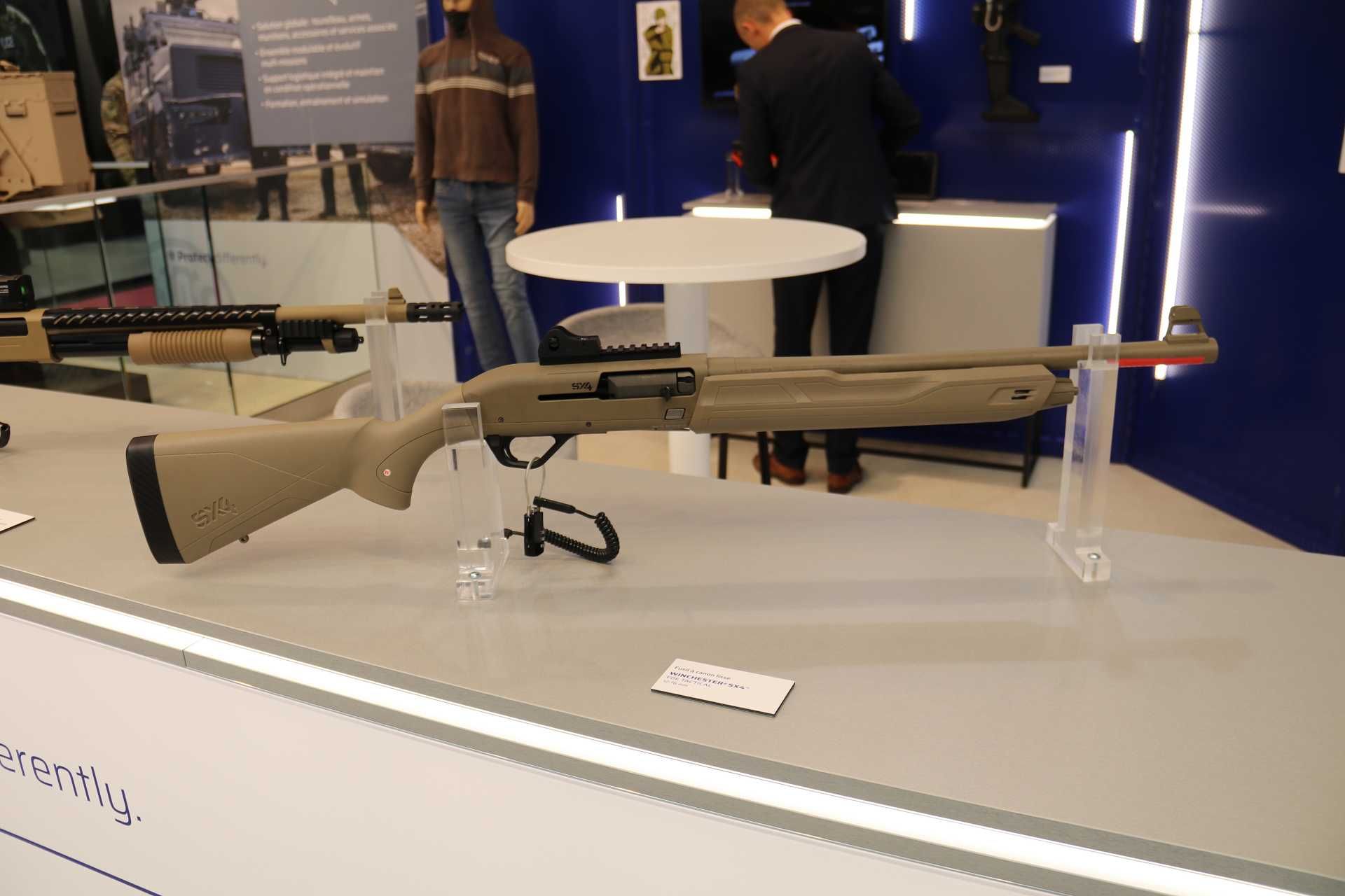 The FN Herstal SX4™ semi-automatic shotgun in its tactical configuration on display at Milipol 2025, optimized for short-range counter-drone operations with red dot optic compatibility and mission-adapted ammunition.