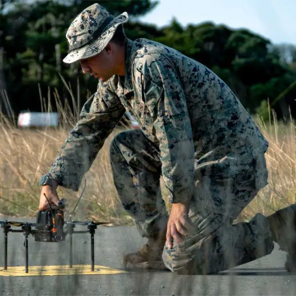 A U.S. Marine assigned to III Marine Expeditionary Force prepares an unmanned aerial system during the Marine Corps Attack Drone Competition at Camp Schwab, Okinawa, Japan.