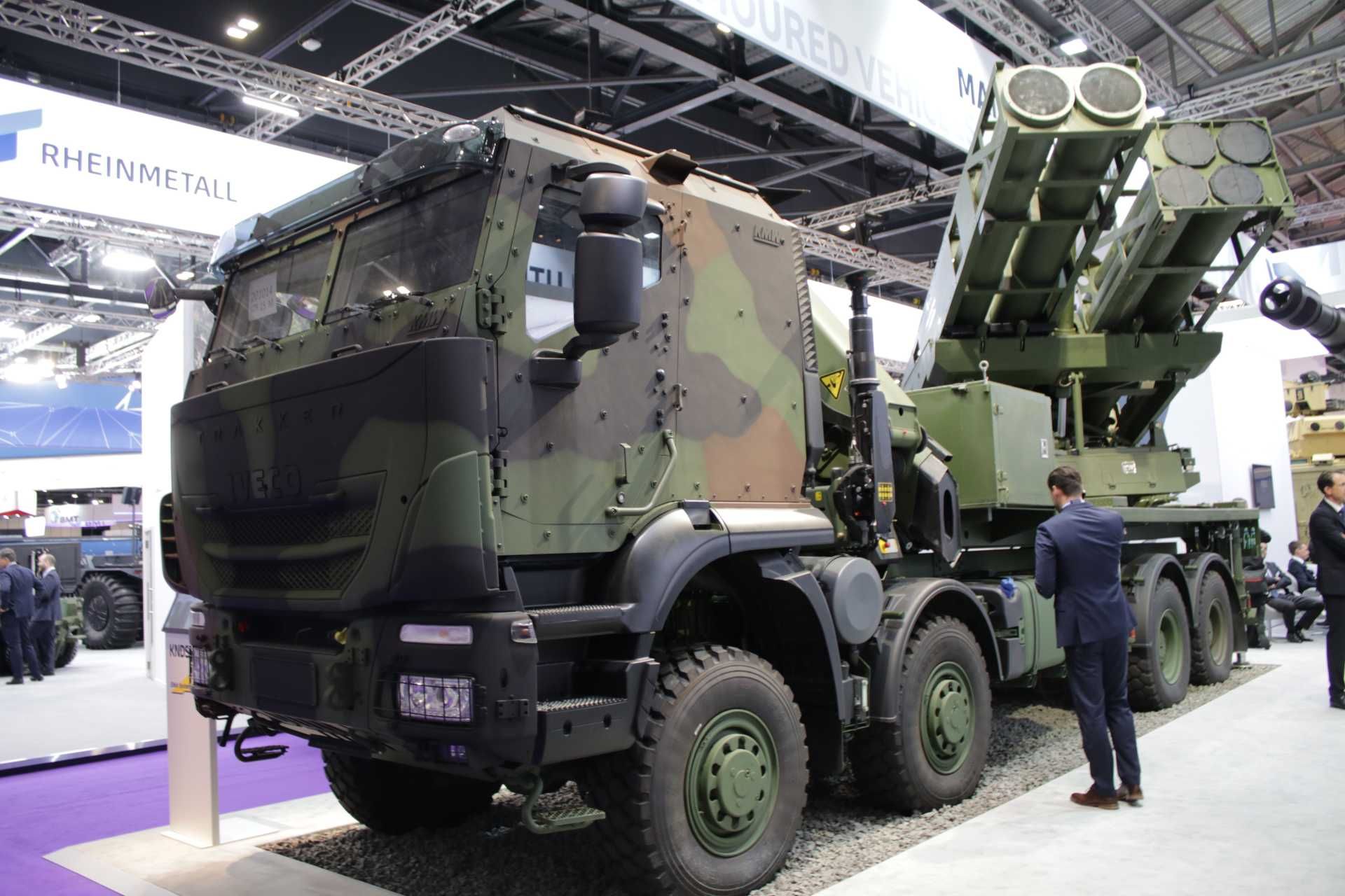 Elbit Systems' PULS (Precise and Universal Launching System) on display at DSEI 2023 in London, showcasing its modular dual-pod launcher configuration and 6x6 high-mobility platform, capable of firing multiple rocket calibers up to 300 km range.