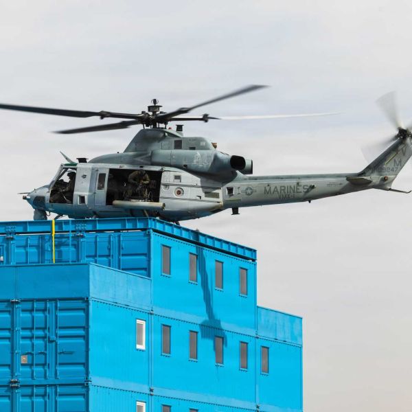 A UH-1Y Venom helicopter from the U.S. Marine Corps, operated by Marine Operational Test and Evaluation Squadron 1, practices simulated rooftop insertion maneuvers at Deuce Village within the Berry M. Goldwater Range Complex near Yuma, Arizona, on January 21, 2026.