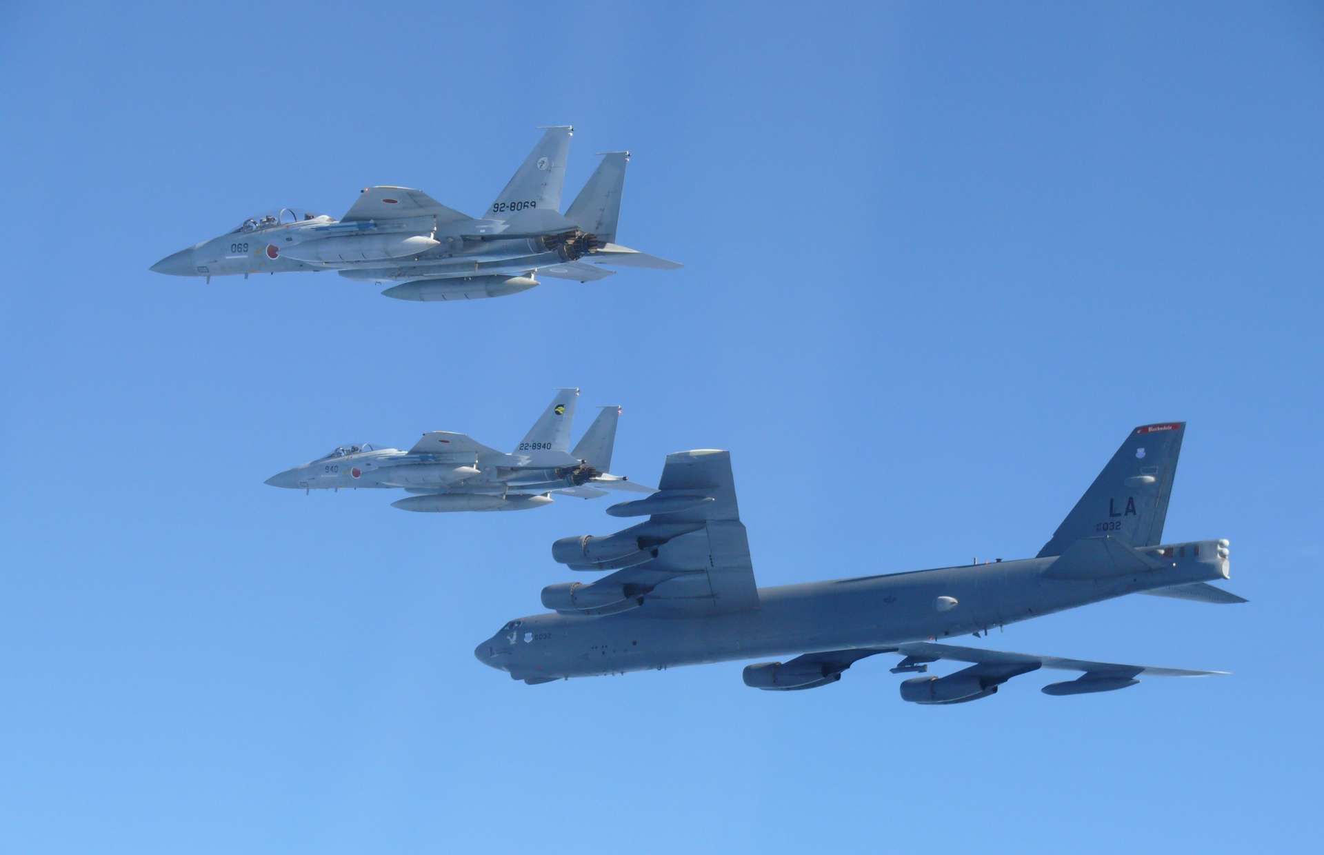 U.S. B-52 bombers fly with Japan’s F-15J and F-35A fighters over the Sea of Japan in a show of alliance deterrence days after a joint Chinese Russian bomber patrol, underscoring rising Indo-Pacific airpower tensions (Picture source: Japan MoD)