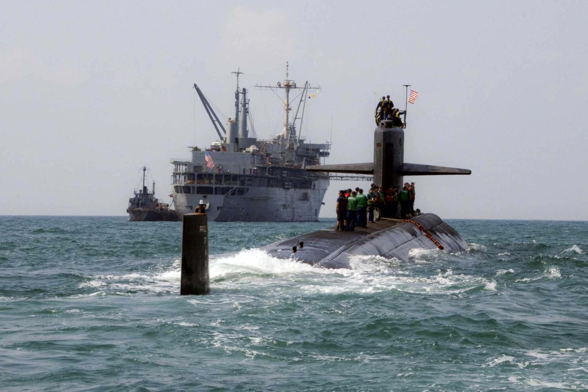 A submarine tender, such as the USS Frank Cable (AS-40), is basically a floating base that lets submarines stay on mission longer by repairing and resupplying them without forcing them to go back home. (Picture source: US Navy)