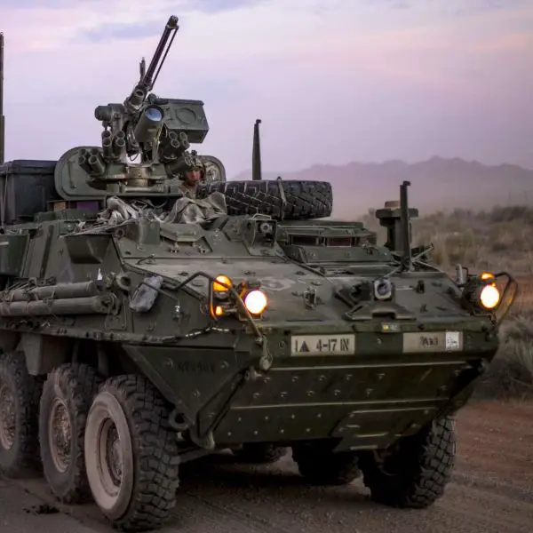 A U.S. Army Stryker from the 1st Brigade Combat Team, 4th Battalion, 17th Infantry Regiment maneuvers past a Combat Aviation Brigade convoy during movement to the division-level Iron Focus field exercise, illustrating coordinated ground and aviation operations (Picture Source: DVIDS)