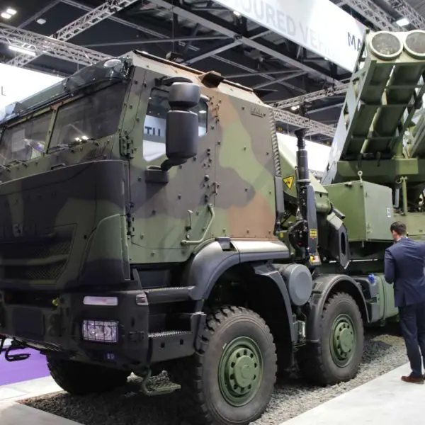 Elbit Systems' PULS (Precise and Universal Launching System) on display at DSEI 2023 in London, showcasing its modular dual-pod launcher configuration and 6x6 high-mobility platform, capable of firing multiple rocket calibers up to 300 km range.
