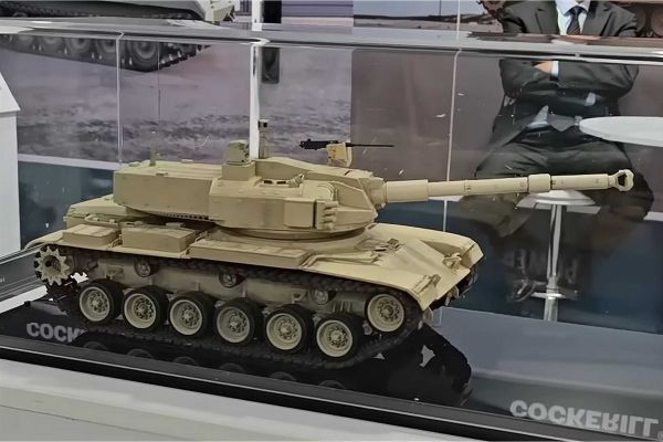 Scale model of the upgraded M60 tank featuring the John Cockerill 3105 weapon station on display at the John Cockerill Defense booth during EDEX 2025 in Cairo, Egypt. The concept illustrates a turret-replacement solution to revitalize legacy U.S.-made tanks with modern firepower and digital systems.