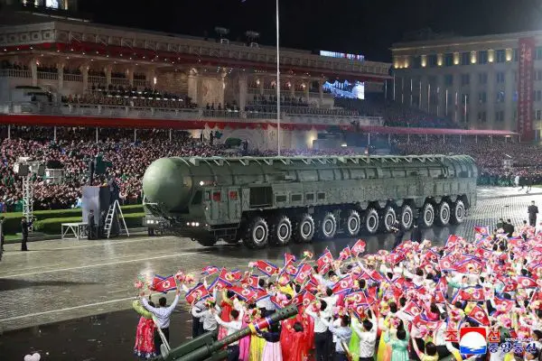 The Hwasong 20 intercontinental ballistic missile moves through central Pyongyang during North Korea’s October 2025 military parade, carried on an enlarged transporter launcher that analysts say underscores the regime’s push for greater range, mobility, and nuclear survivability.