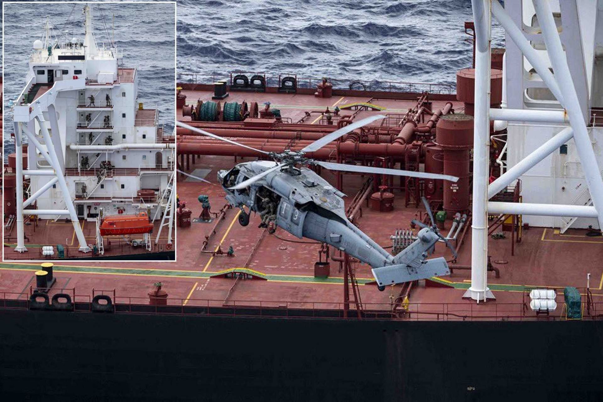 U.S. Navy MH-60R Seahawk inserts a boarding team onto the oil tanker Veronica III during a sanctions enforcement operation conducted under the protection of an Arleigh Burke-class guided missile destroyer in international waters.