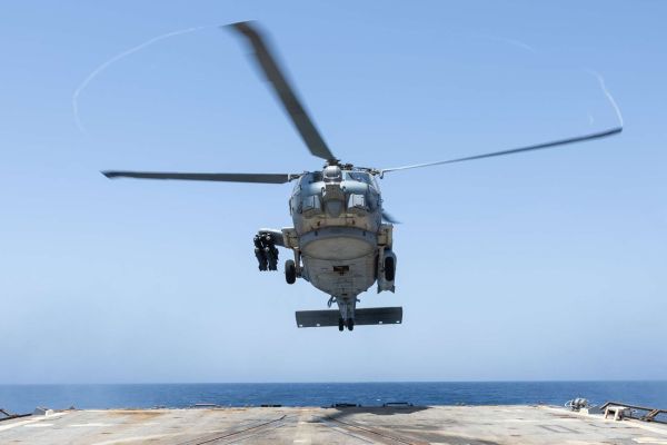 An MH-60R Seahawk from Helicopter Maritime Strike Squadron 50 lands aboard USS Truxtun in the Arabian Sea, where its sensors and precision weapons support U.S. blockade enforcement, maritime surveillance, and force protection near the Strait of Hormuz (Picture source: U.S. DoW).