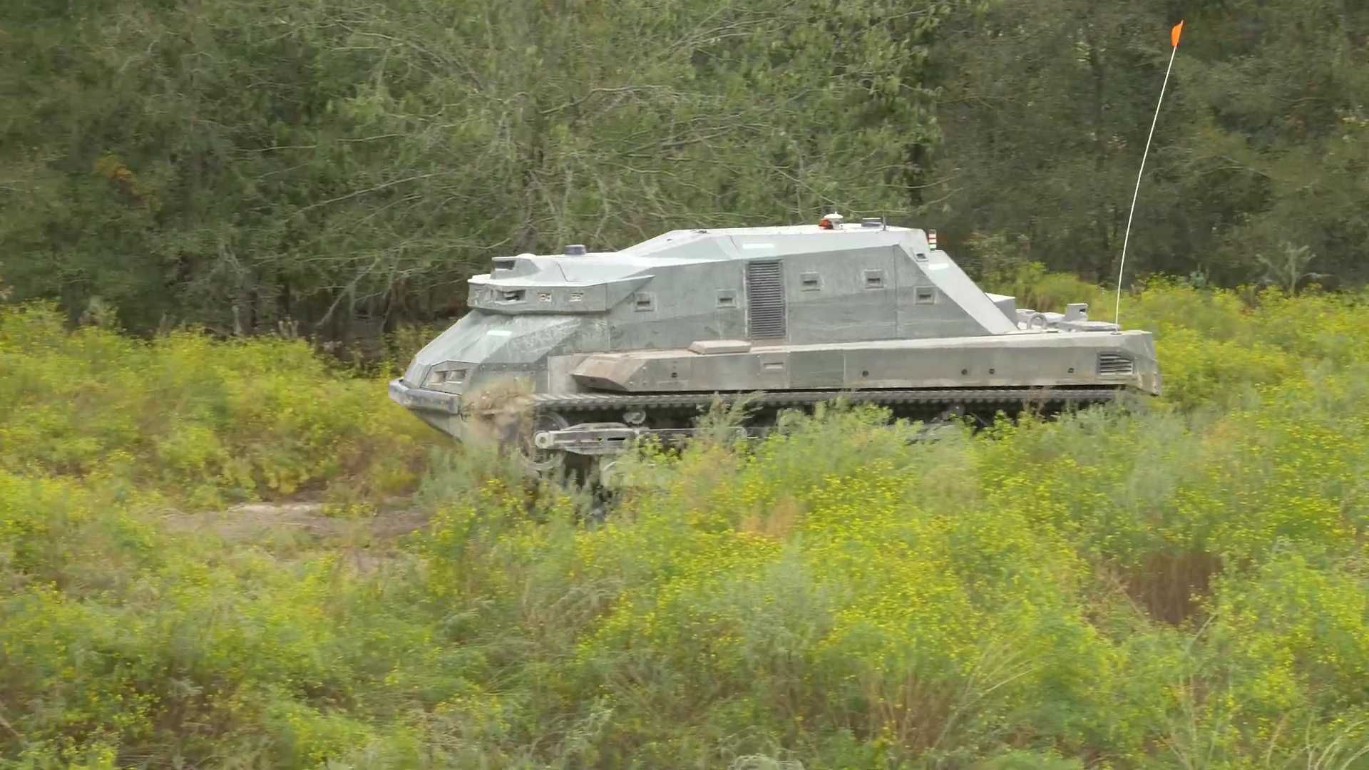 The RACER Heavy Platform is a tracked, skid-steer vehicle based on the Textron M5 vehicle and measures approximately 20 feet long with a total weight of around 12 tons. (Picture source: DARPA)