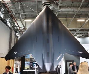 During Eurosatory 2026, Shield AI displayed a redesigned 45% scale model of the X-BAT, which abandoned the original cranked-kite planform and adopted a straight leading edge with greater sweep, producing a sharper arrowhead-shaped flying wing configuration. (Picture source: Army Recognition)